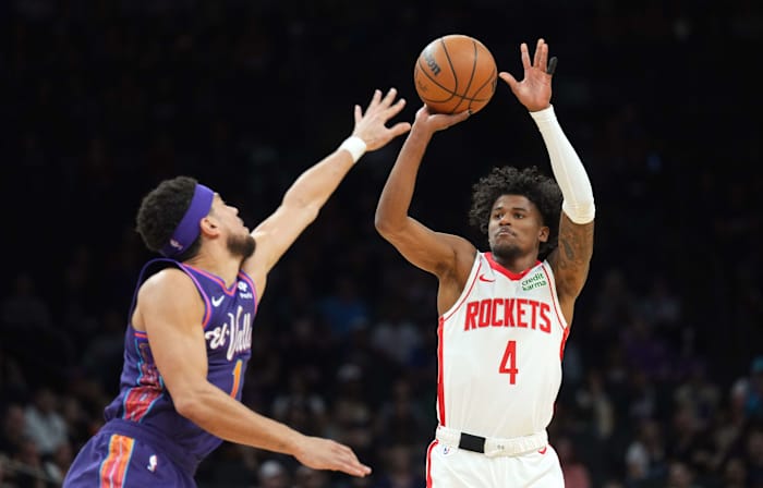 Rockets guard Jalen Green (4) shoots over Phoenix Suns guard Devin Booker (1) during the first half at Footprint Center.